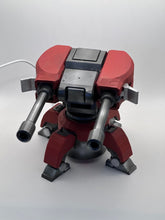 Load image into Gallery viewer, "Image of a 3D Printed Torbjörn Turret Replica from Overwatch in motion. The replica turret is made of high-quality plastic and designed to look like the in-game version. The turret is shown with its signature orange and gray color scheme, and is in mid-rotation with its barrel pointed forward. This replica is perfect for Overwatch fans and collectors who want to add a realistic and unique item to their collection."